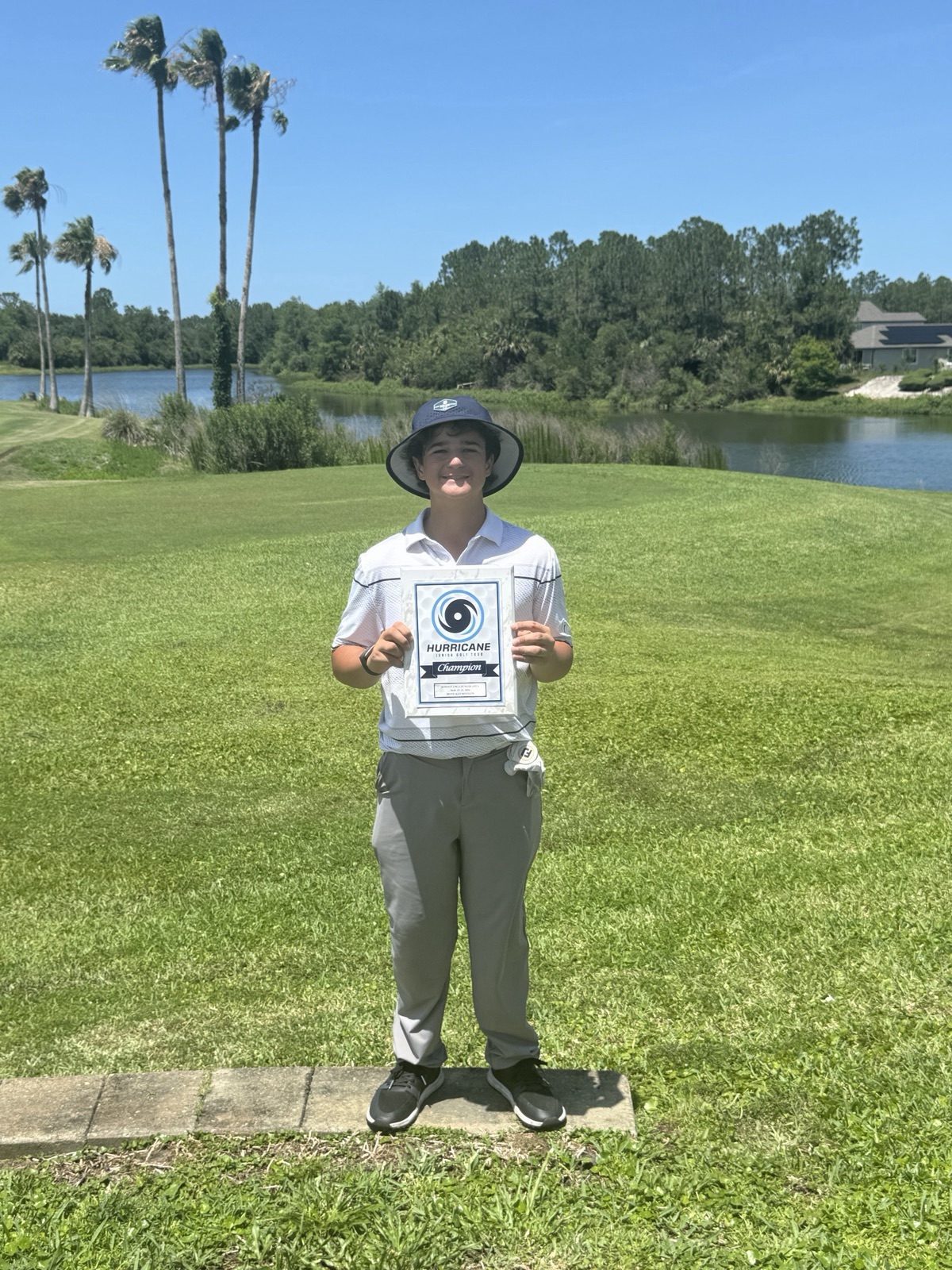 Zeke Varela holding a tournament champion plaque