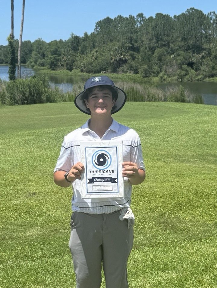 Zeke Varela holding a tournament champion plaque