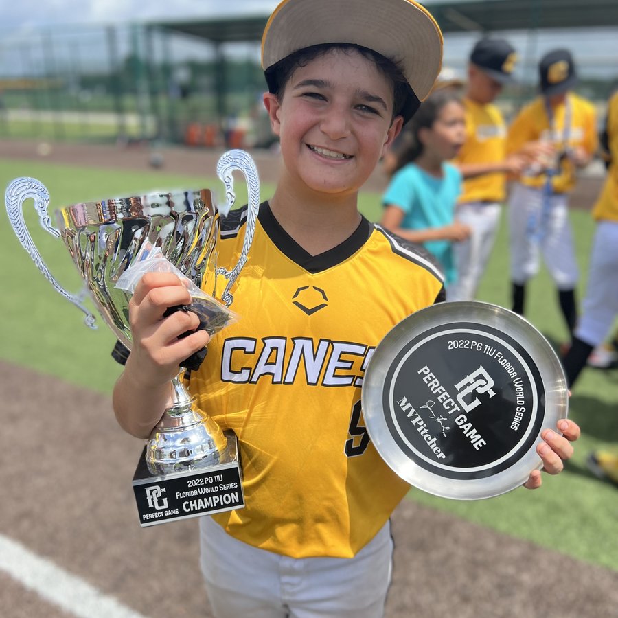 Zeke Varela holding the Perfect Game 11U Florida World Series champion trophy and MV Pitcher award